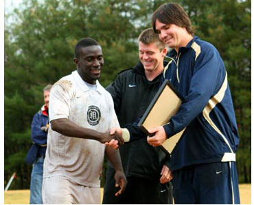 Senior Shaka Bangura shakes hands with Montreat coaches during Senior Day ceremonies